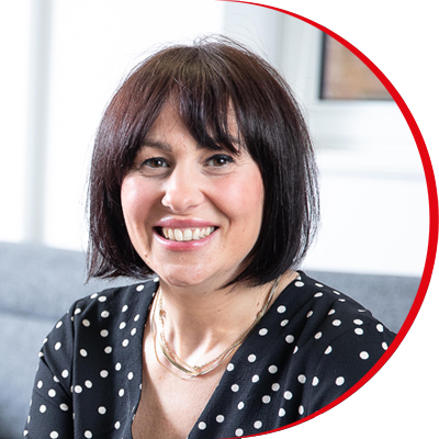 Headshot: Aimee Shimmin, a woman with a short brown bob wearing a polka-dot top.