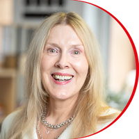 Headshot: Jane Muirhead, a woman with long blonde hair wearing a white top.