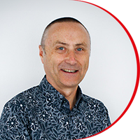 Headshot: Steve Warr, a man with very short hair, wearing a blue patterned shirt.