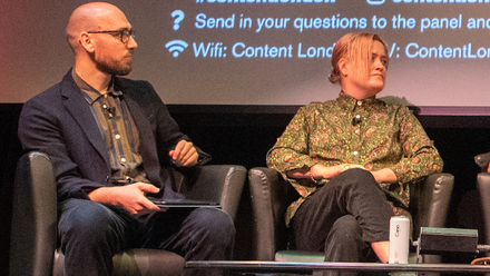 Photo of panellists on stage at Content London, sat in front of a large screen.