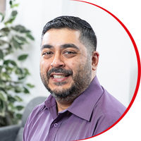 Headshot: Anish Khanderia, a man with short dark hair and beard wearing a purple shirt.