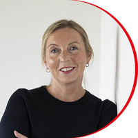 Headshot: Claire Mundell, a woman with fair hair tied back from her face, wearing a dark top.