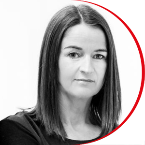 Headshot: Christine Healey - a woman with shoulder-length straight brown hair wearing a black top.