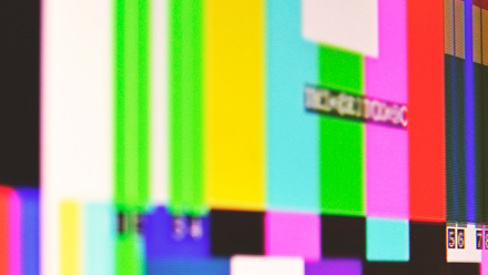 Close up image on a screen with broadcast colour bars on it.